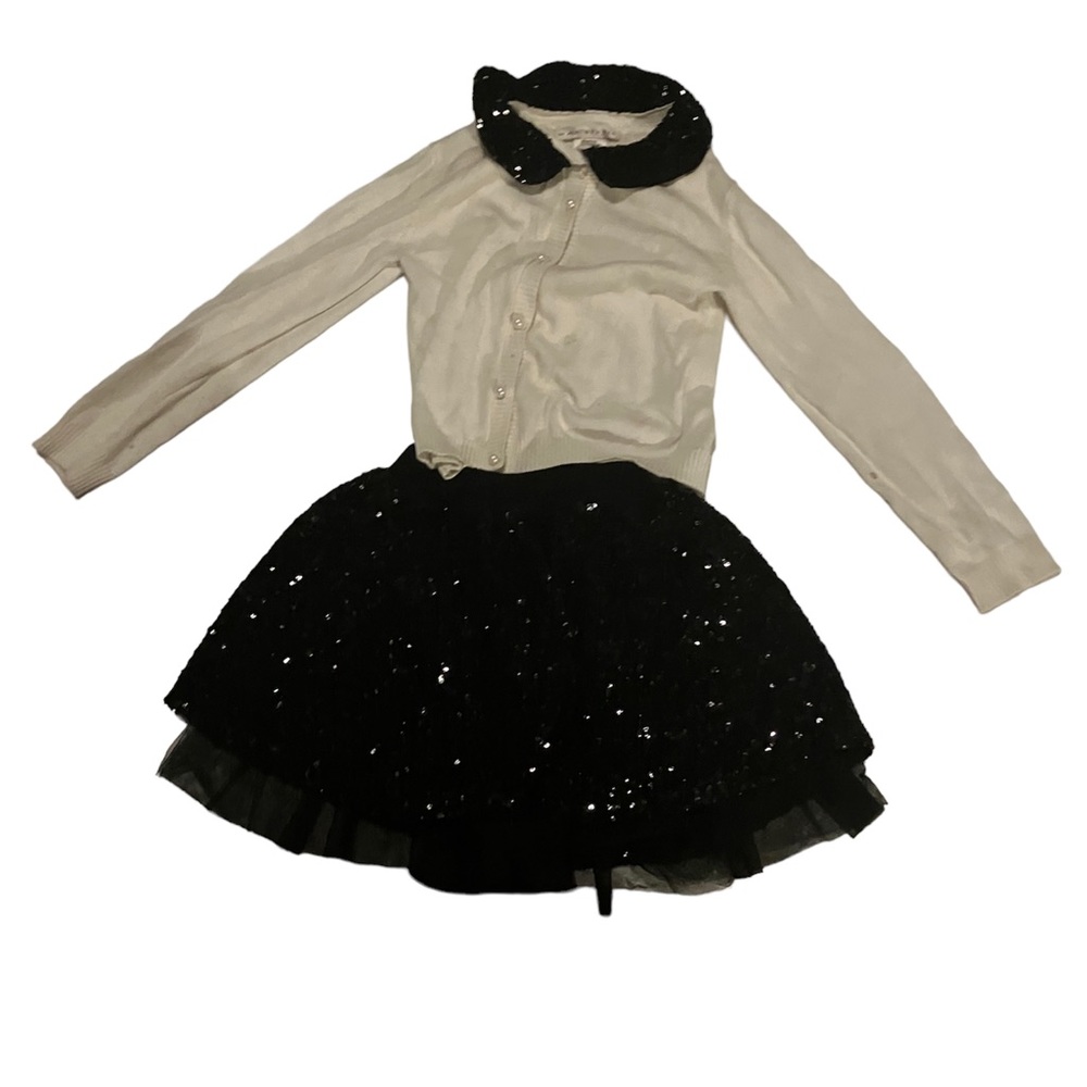Long sleeved  sweater with black sequence skirt.